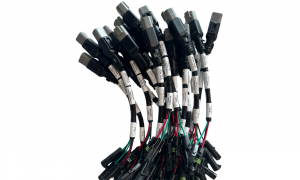 Custom industrial wire harness bundles with circular multi-pin connectors on assembly table