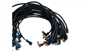 Custom industrial wire harness bundles with circular multi-pin connectors on assembly table