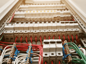 Industrial control panel with circuit breakers, terminal blocks, and organized wiring connections