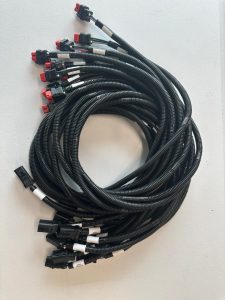 Custom industrial wire harness assembly with corrugated conduit and multiple sealed connectors