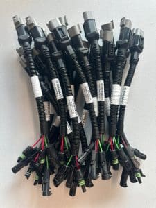 Custom multi-connector wire harness assemblies with protective corrugated loom and sealed terminals