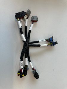 Custom electrical wire harness assembly with multiple sealed connectors and protective corrugated loom