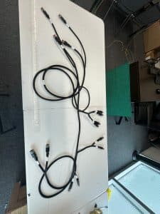 Custom multi-branch cable assembly with sealed connectors and labeled wiring laid out for inspection