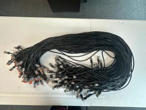 Bulk custom cable assemblies with sealed automotive connectors arranged for inspection and testing